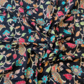 Close-up of floral patterned fabric with colorful flowers on a black background