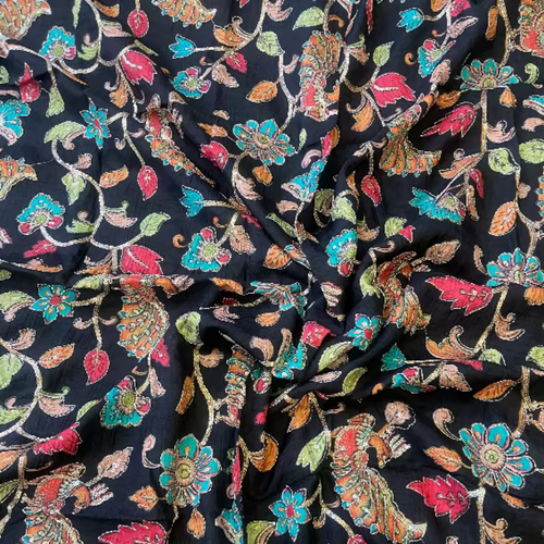 Close-up of floral patterned fabric with colorful flowers on a black background