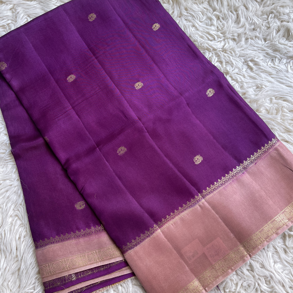 Viscous Dola Silk Purple Saree With Pink Border on a white textured surface