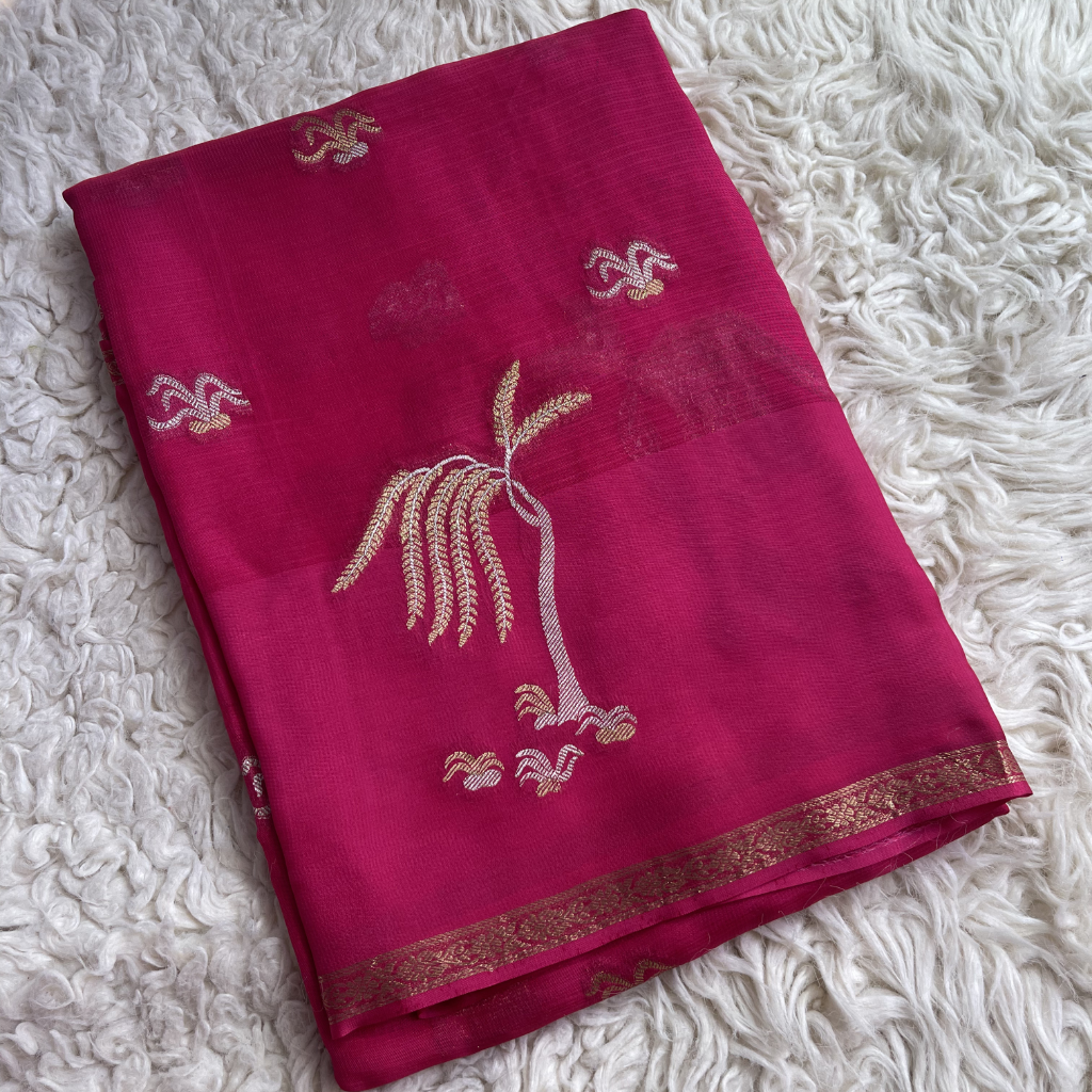 Manipuri Pink Saree with gold embroidery on a white textured surface