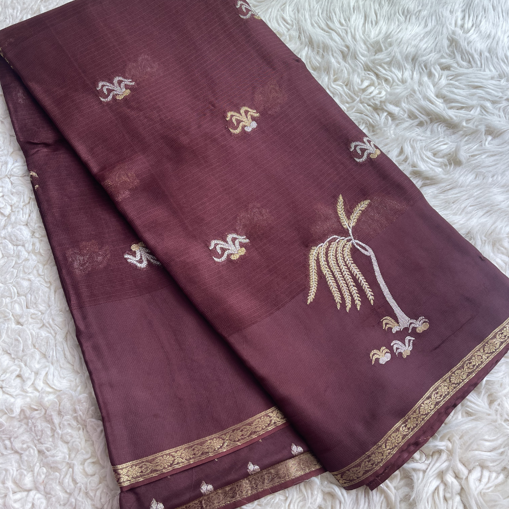 Manipuri Maroon Saree with gold embroidery on a white textured surface